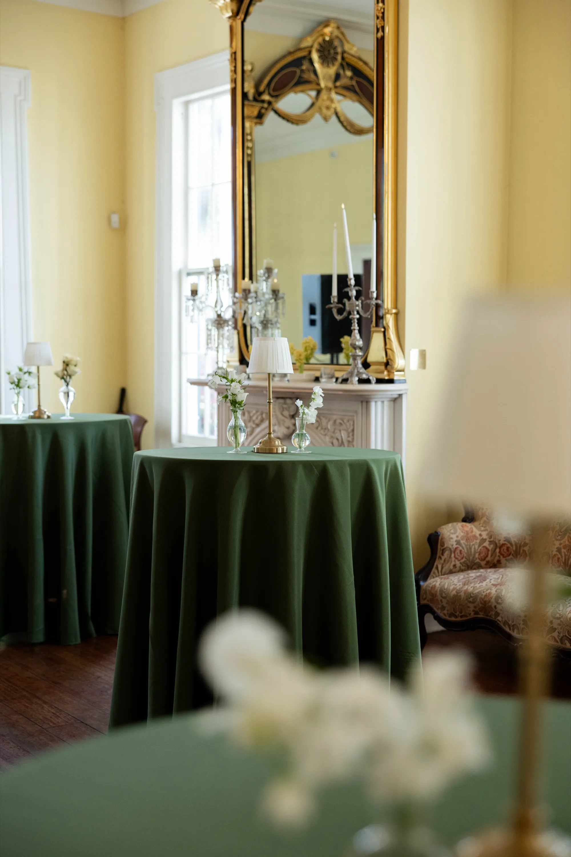 Green linens and candlelight in the mansion's yellow parlor