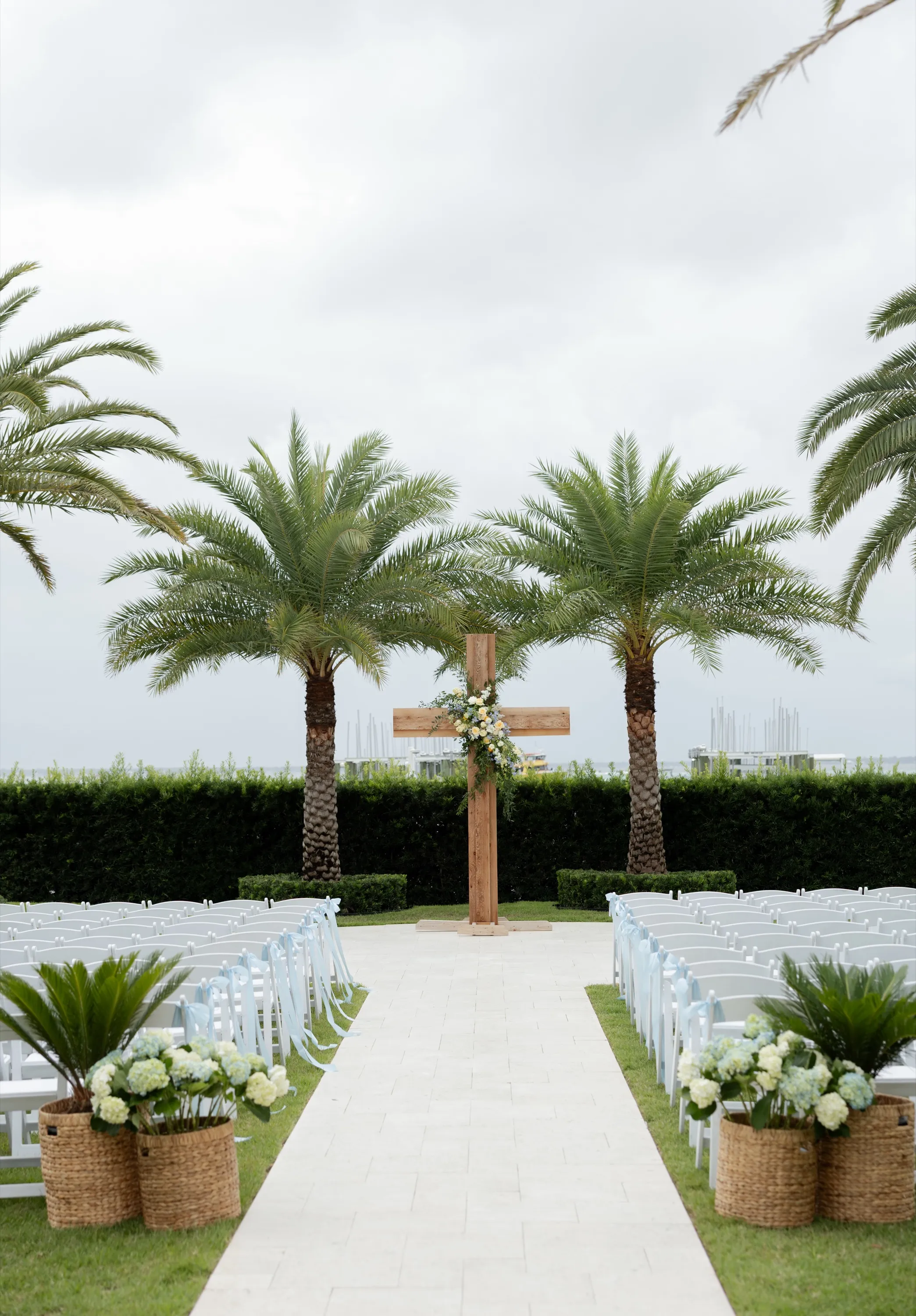 The ceremony site — two palms and a wooden cross dressed in blue and yellow