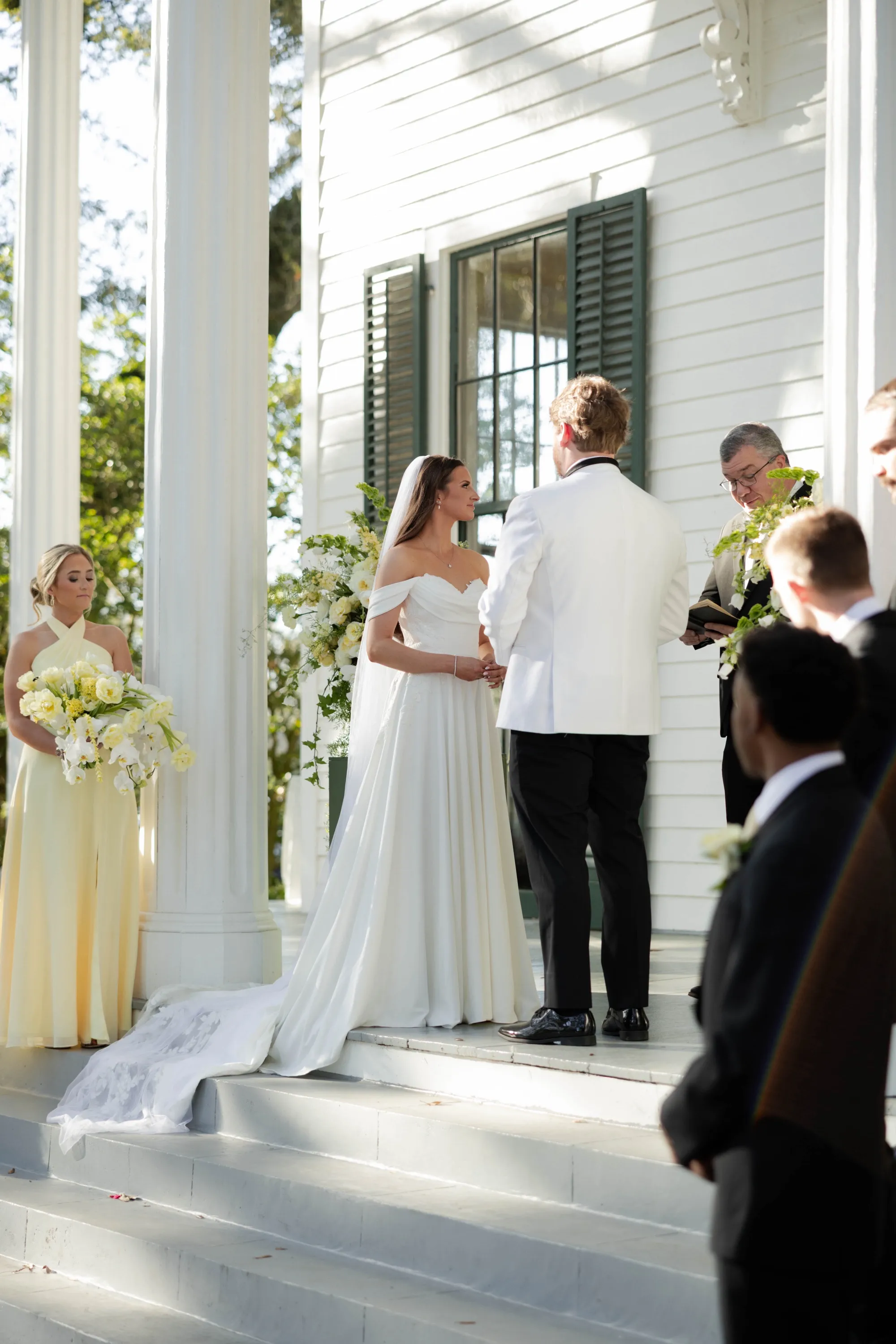 Vows on the mansion's front steps, JT in a white dinner jacket