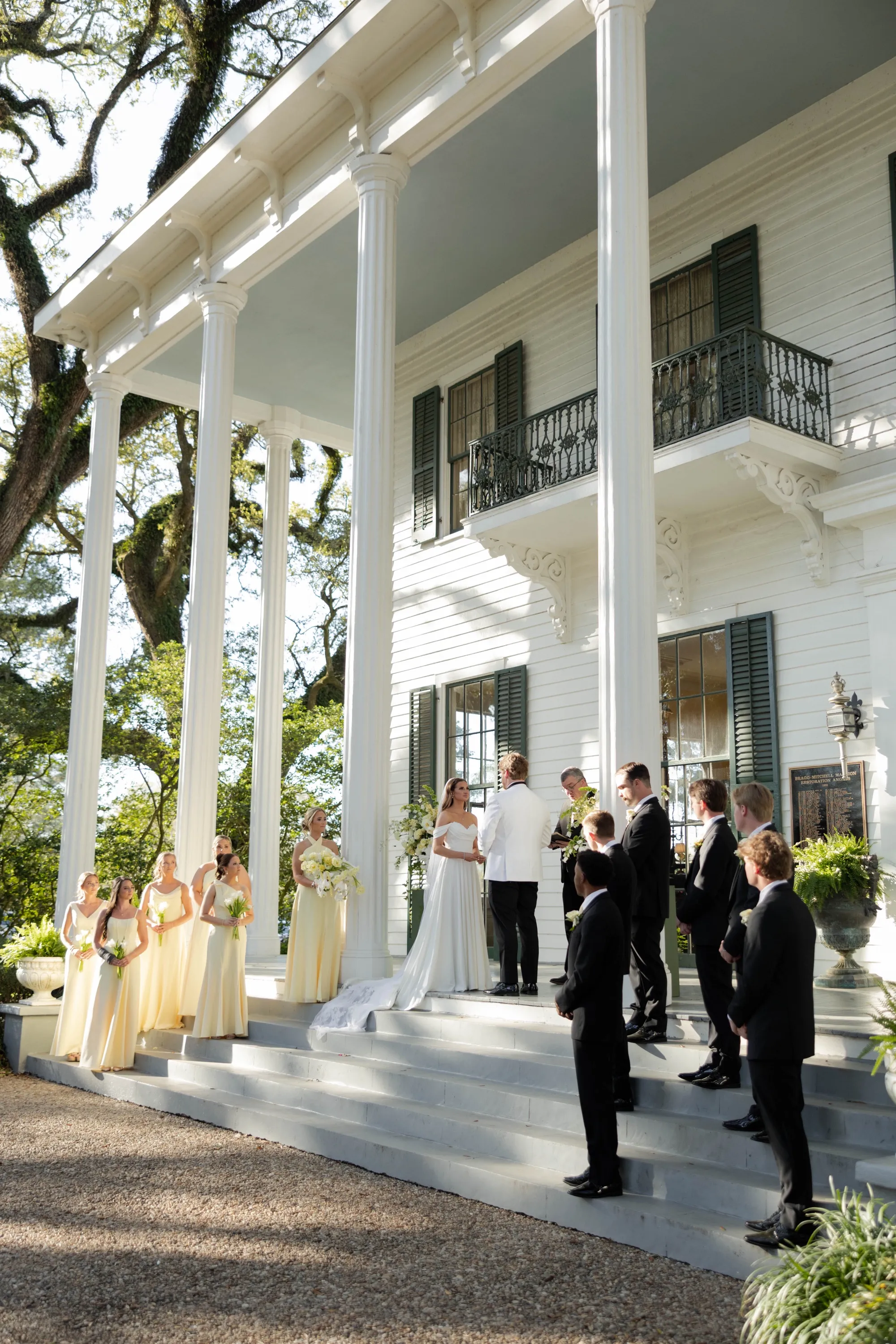 The ceremony beneath the columns of the Bragg Mitchell Mansion