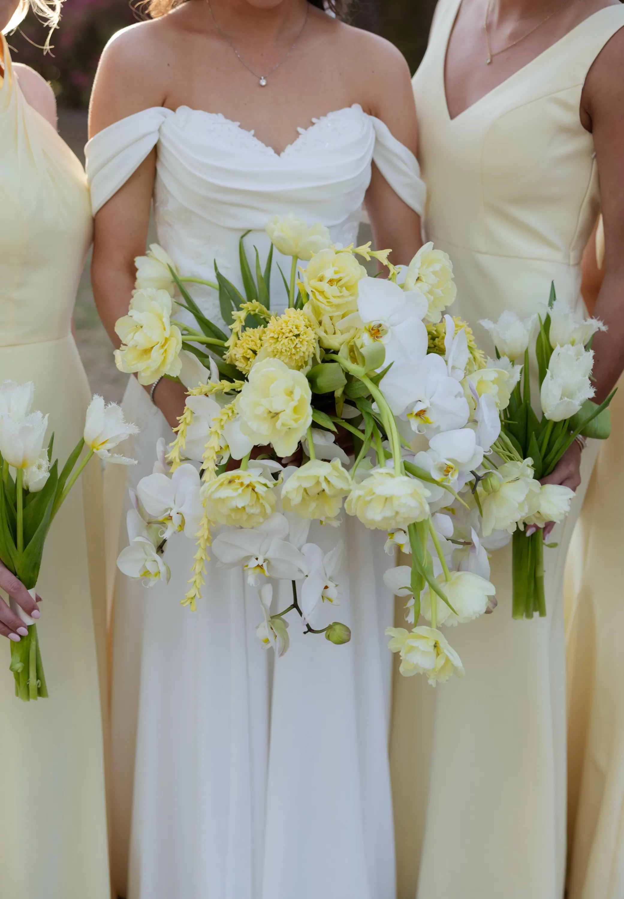 Hallie's bouquet up close — yellow tulips, orchids, trailing blooms
