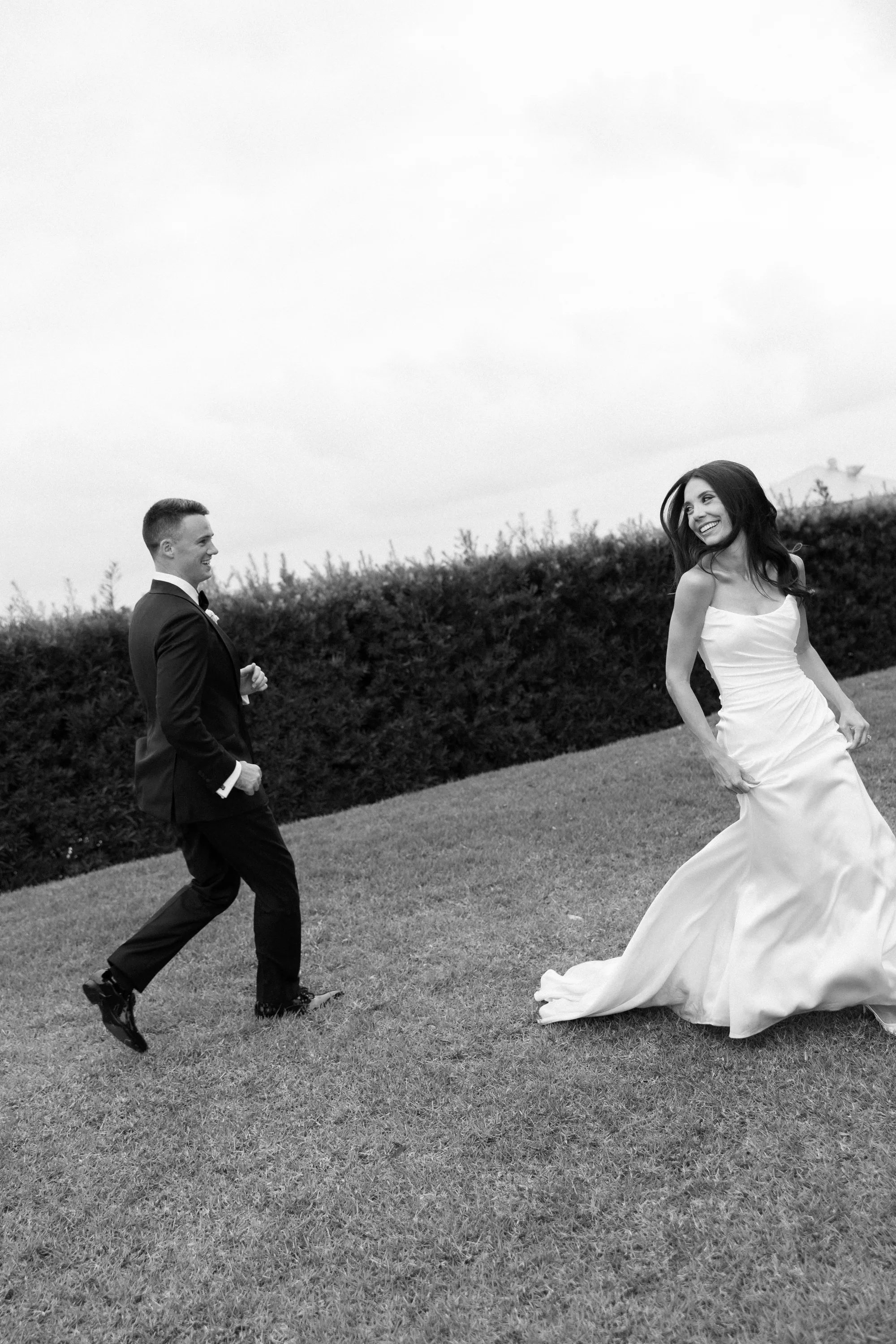 A playful chase across the lawn, in black and white