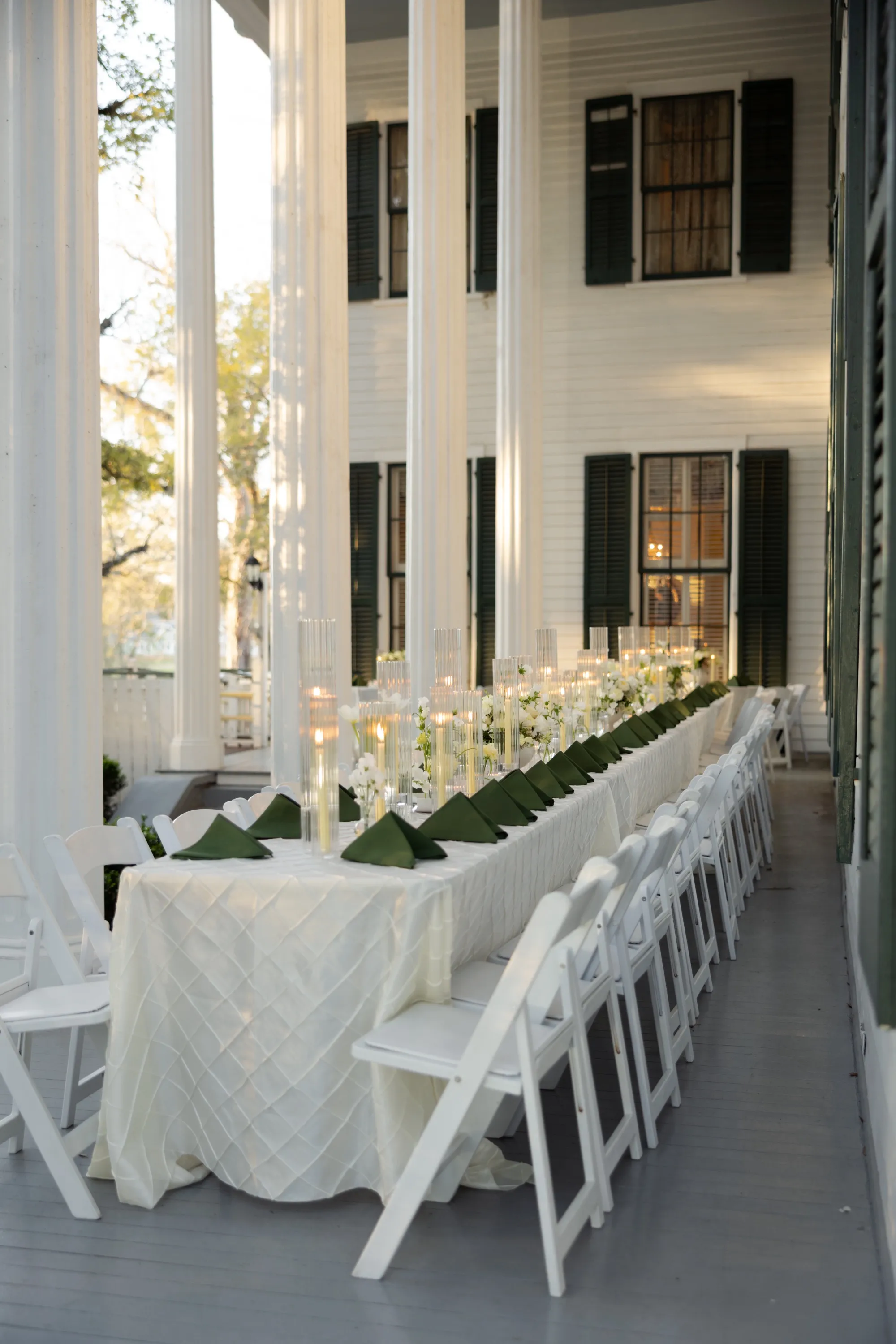 Dinner on the porch — one long table between the columns
