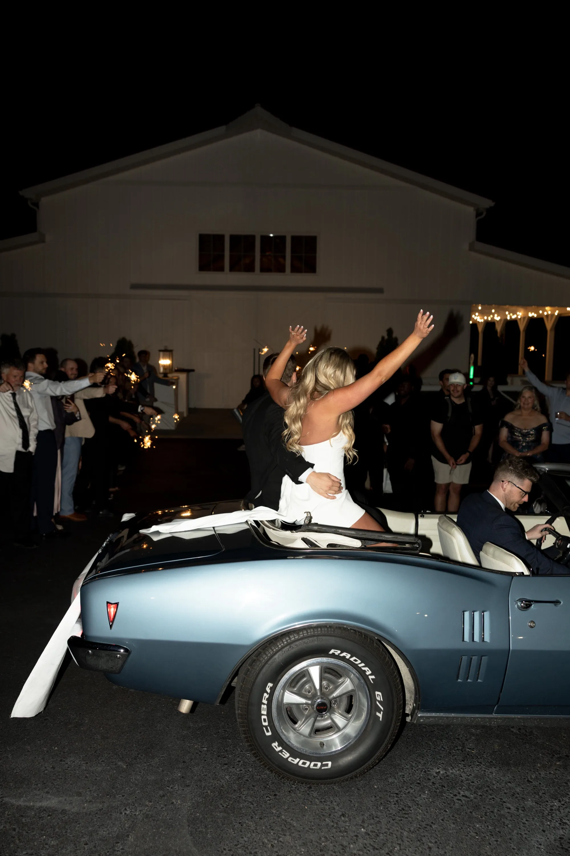 Taylor and Andru show off their rings from the back of the getaway car