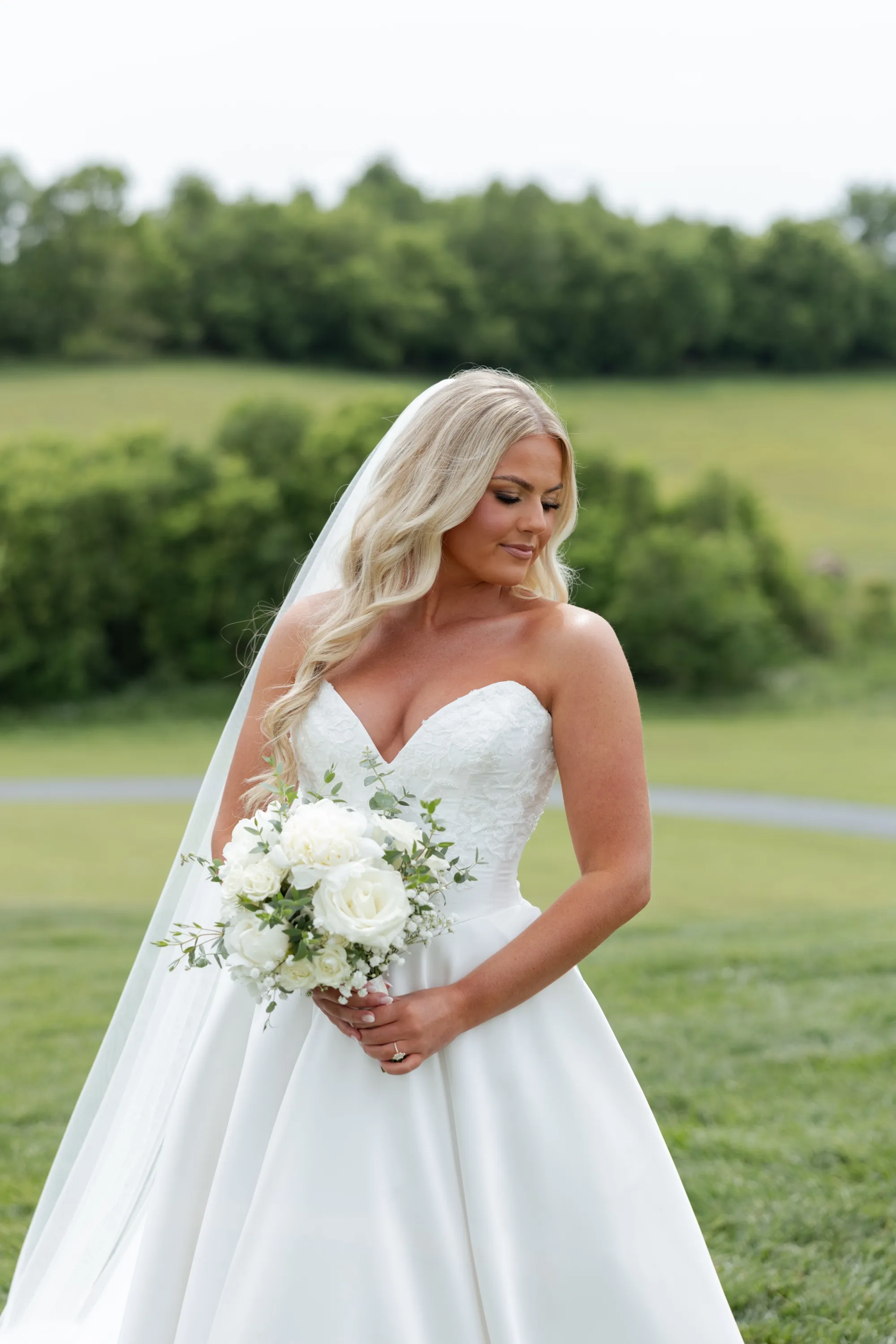 Taylor's bridal portrait in the hills at The White Dove Barn, bouquet in hand