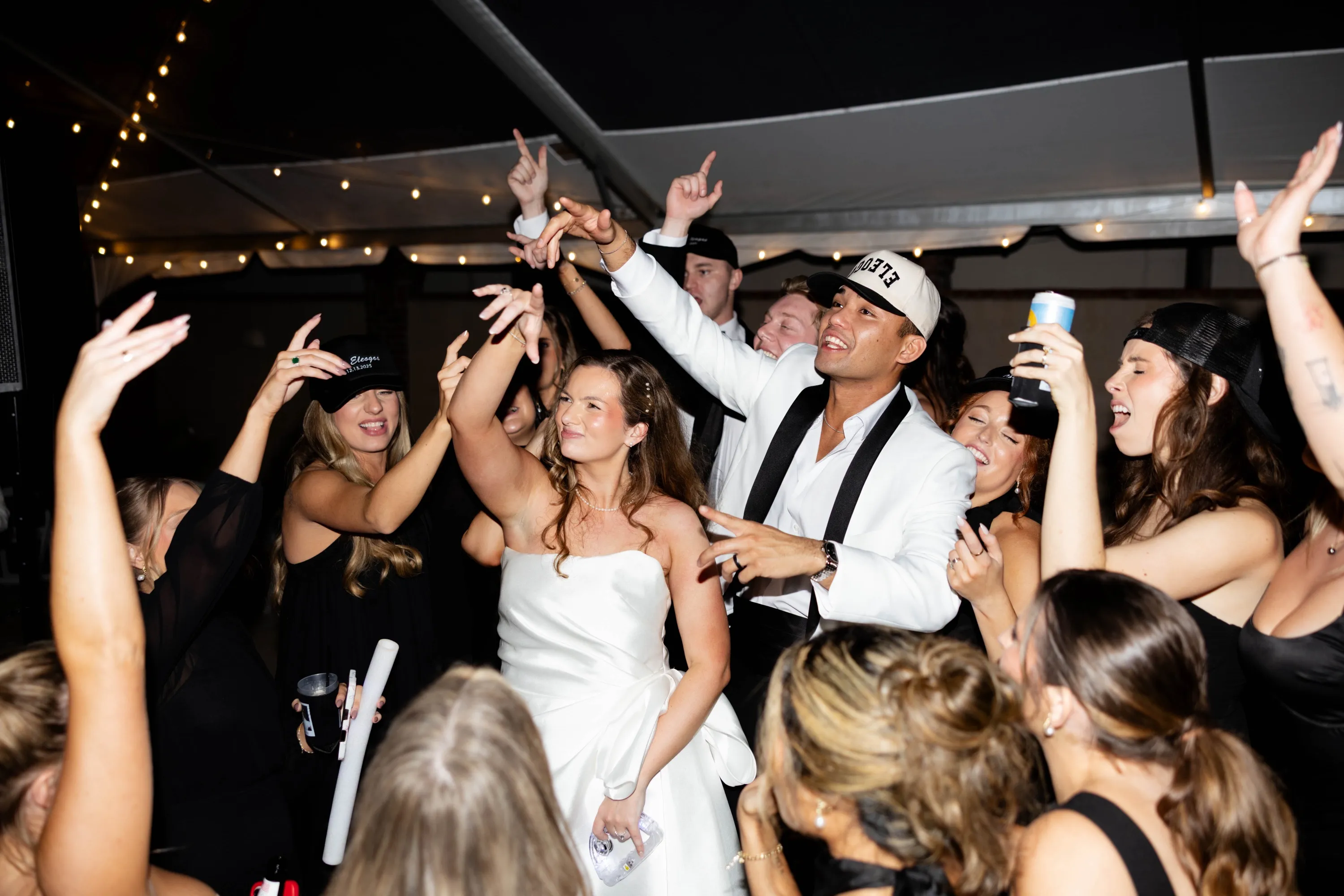 The dance floor at full tilt — Edgar in a white jacket, every hand up