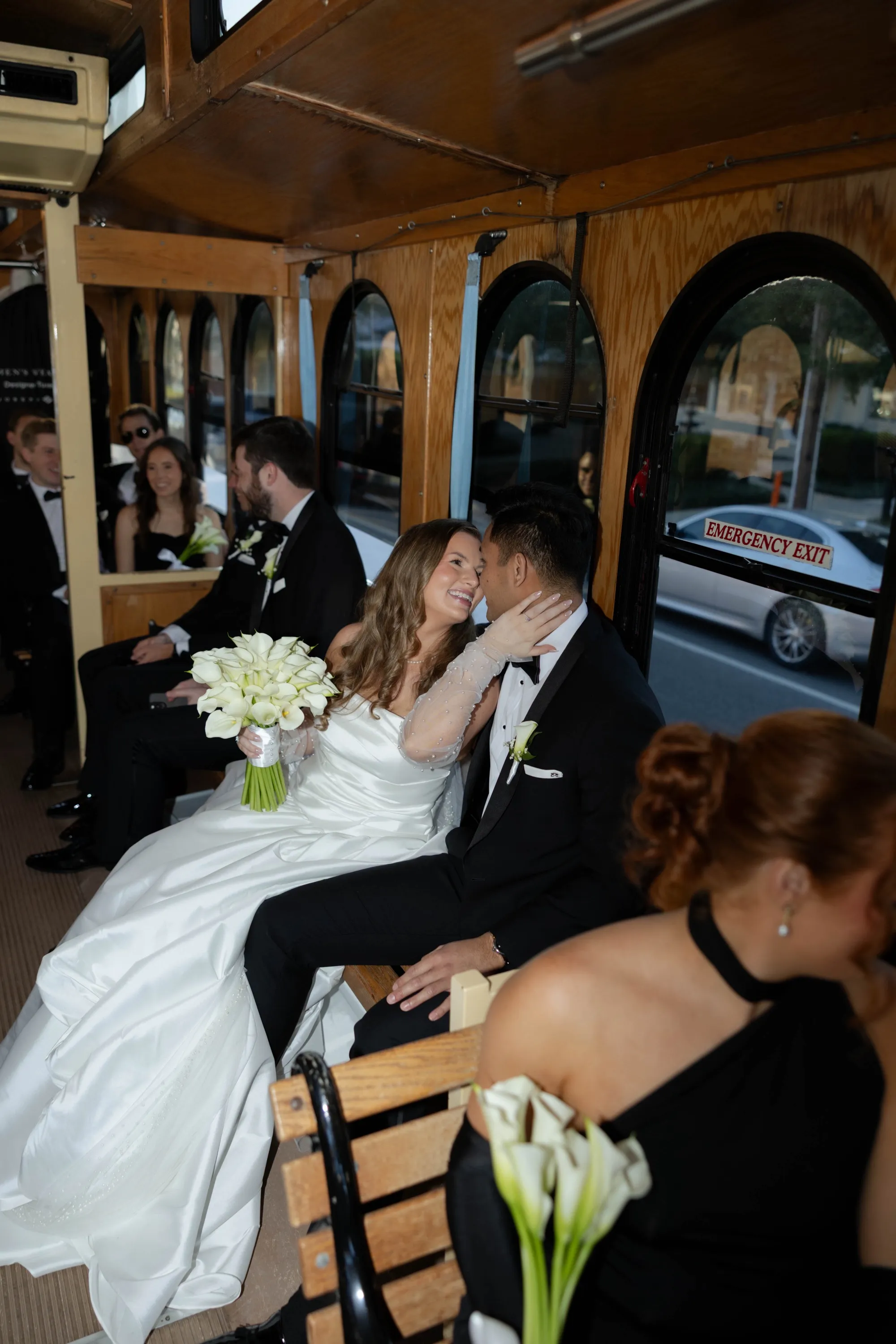 A kiss on the trolley, calla lilies in hand