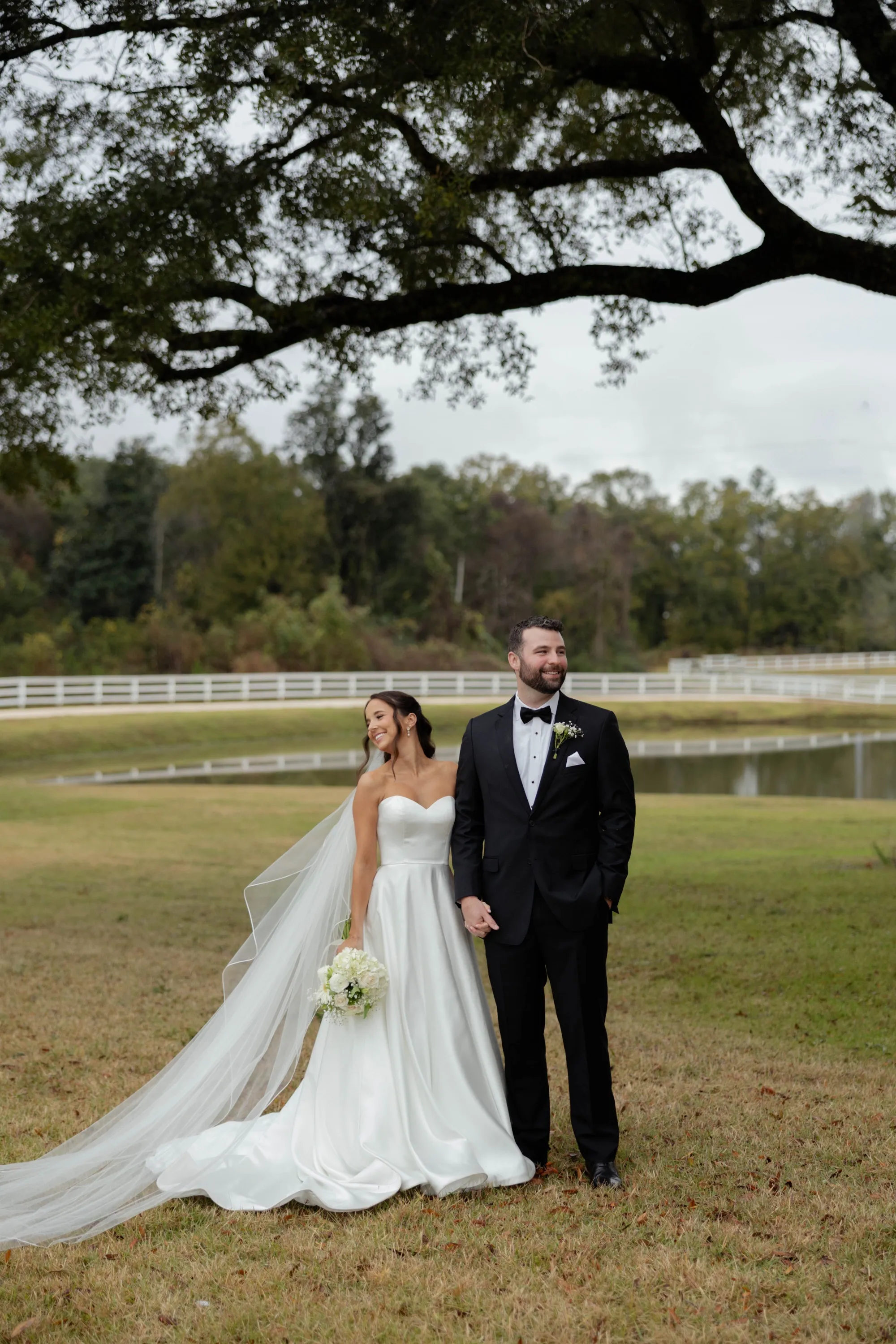 Hand in hand beneath the oak, the rain holding off