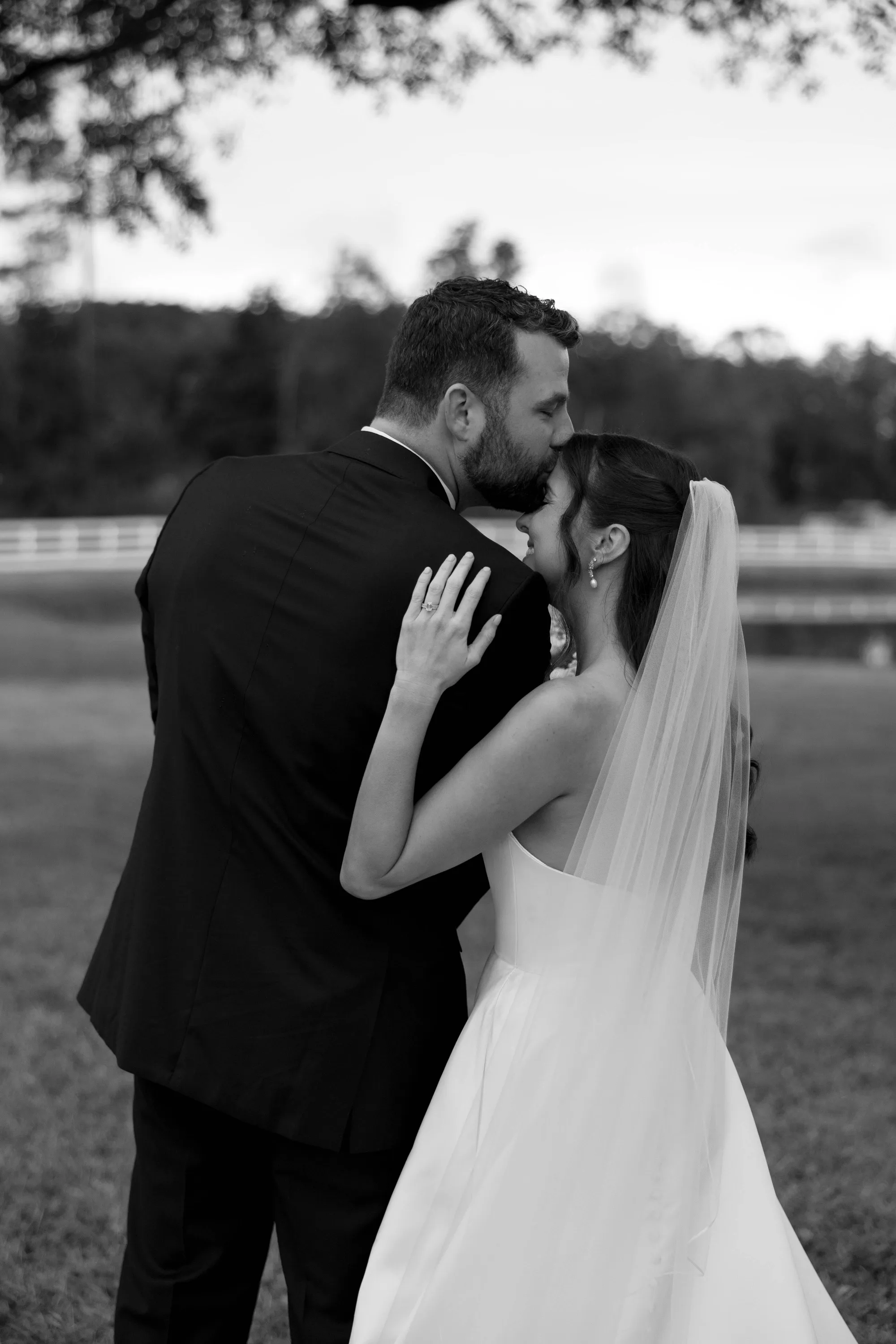 A forehead kiss at dusk, in black and white