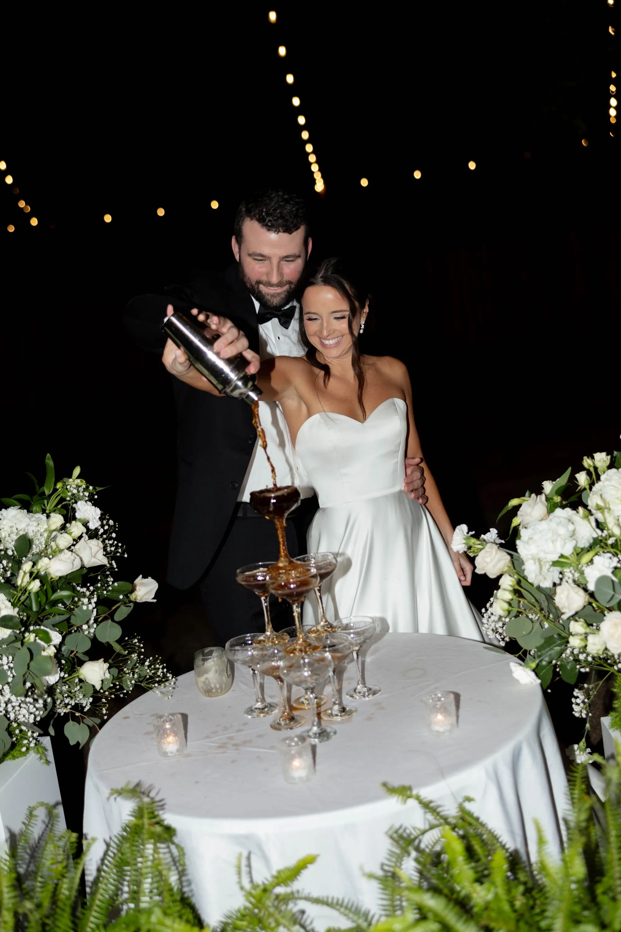 Pouring the tower of coupes under the string lights