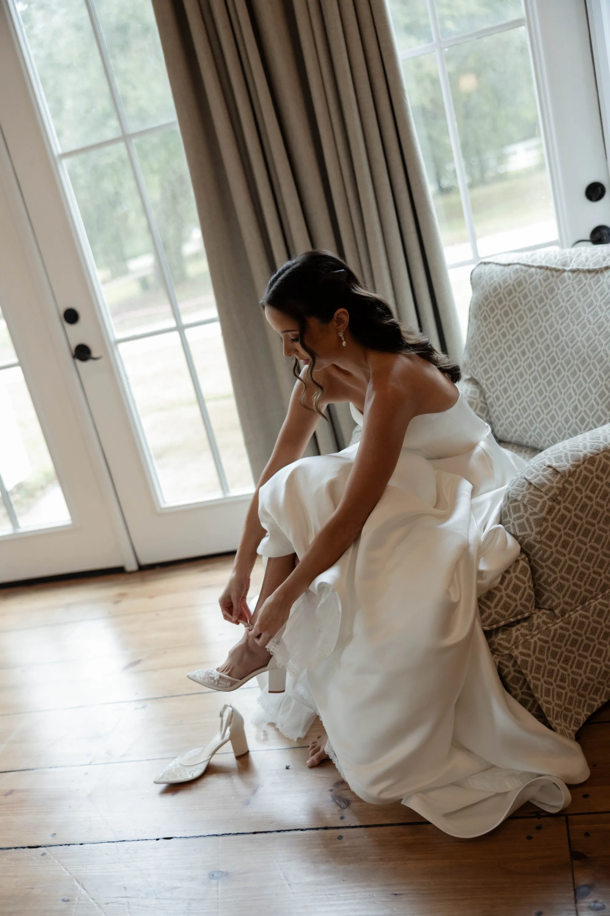 Shelbie fastening her block-heel shoes before the ceremony