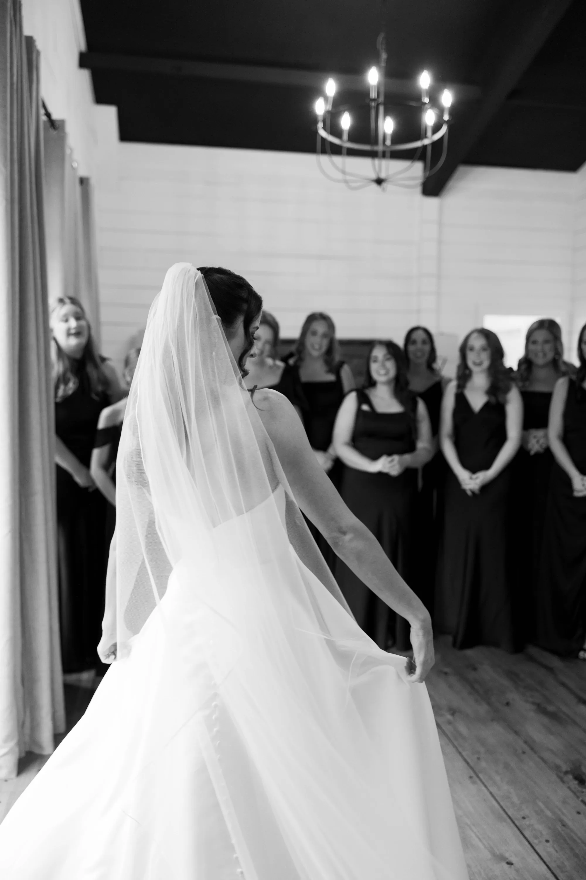 Shelbie twirls her veil for her bridesmaids' first look, in black and white