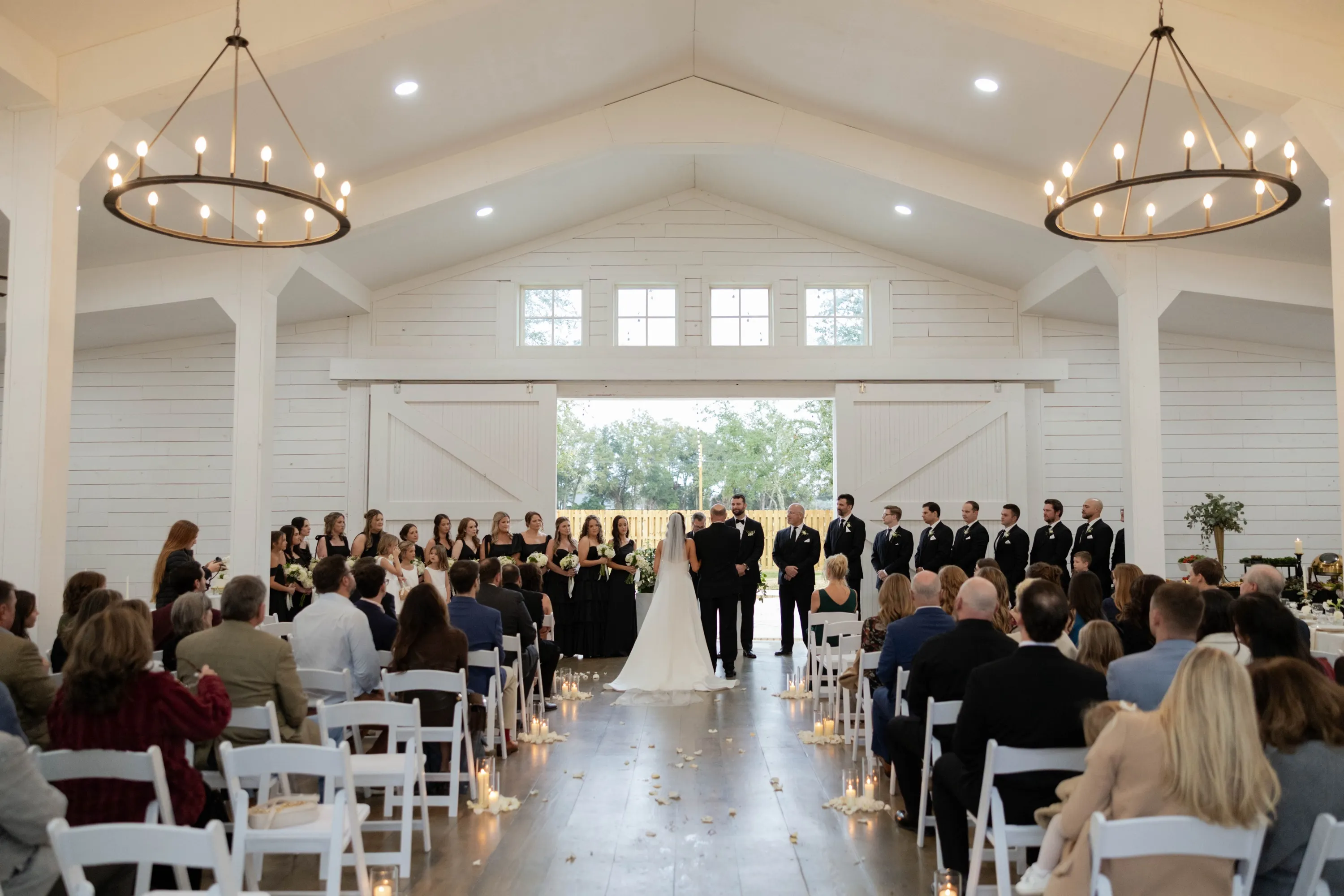The ceremony in the white hall at The Oaks, doors open to the gray day