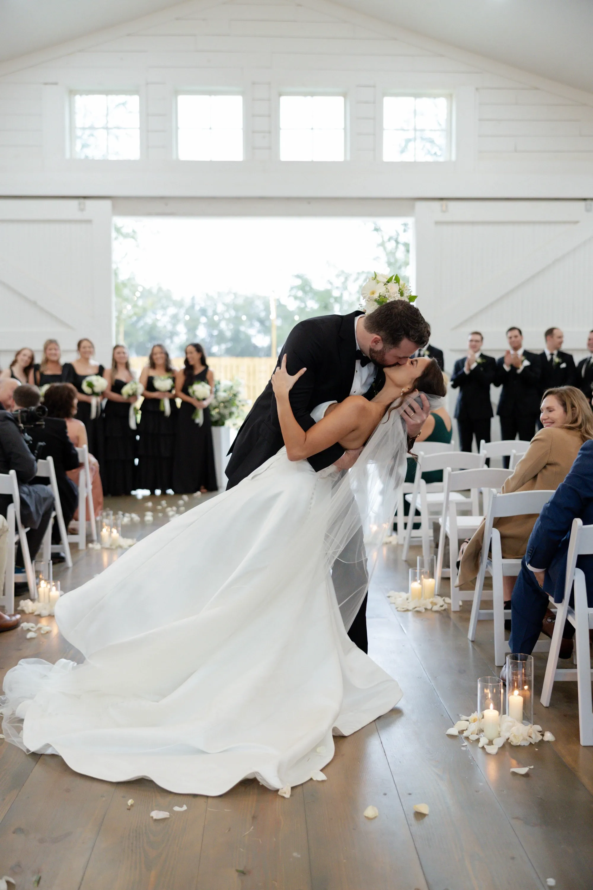 A dip kiss back up the aisle, petals and candlelight