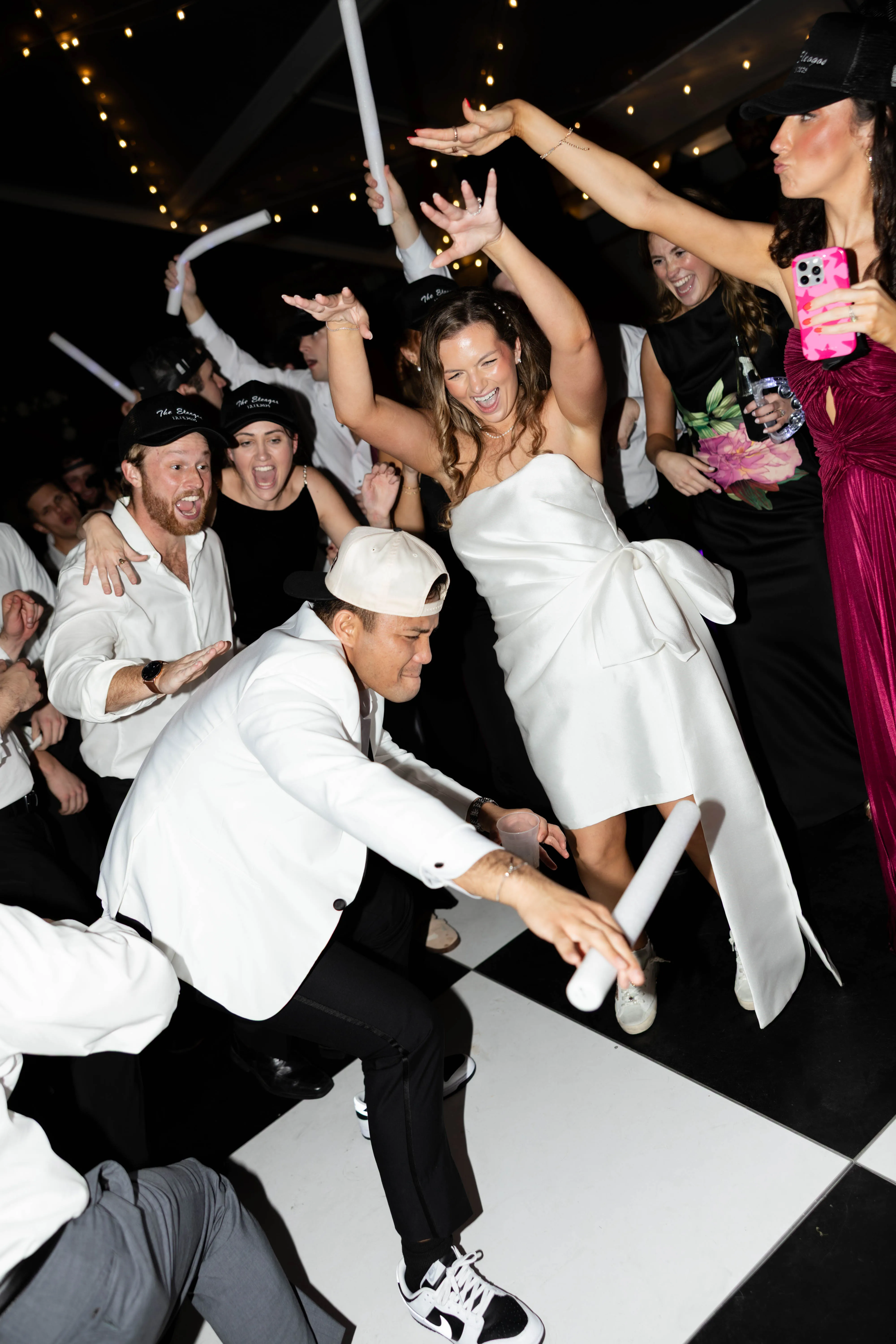 A crowded dance floor mid-song, the couple in the middle of it all